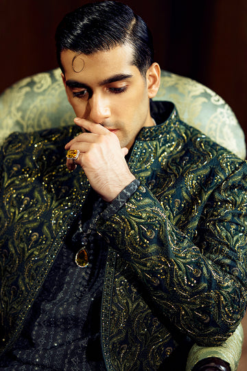 Shop designer embroidered green sherwani for groom with intricate gold detailing, available for online purchase. Perfect traditional attire for weddings and special occasions.